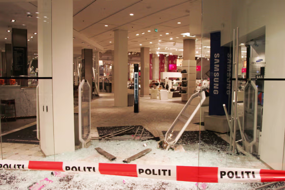 Police in Copenhagen, Denmark, have secured the scene of an attempted robbery in which the would-be thieves raced their car through the ground floor of a department store.