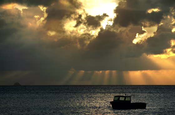A small fishing boat sits moored all alone at sunset near Lindburg Bay, St. Thomas, U.S. Virgin Islands. USVI is an easy getaway that may be especially appealing to Americans who don't have passports.