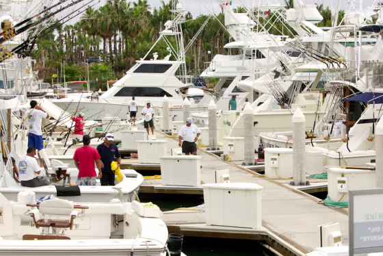 Sports fishermen&nbsp;work on their boats in the resort town of Cabo San Lucas, Mexico, where they're locked in battle with commercial boats hauling out marlin.