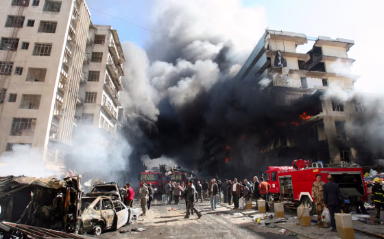 Smoke billows from buildings after a double car bomb attack in central Baghdad on Monday.