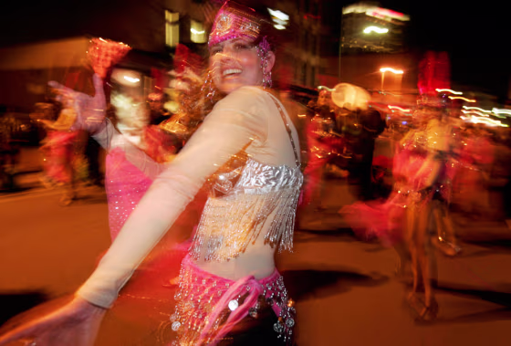 Member of a dance troop performs during Mardi Gras parade in New Orleans