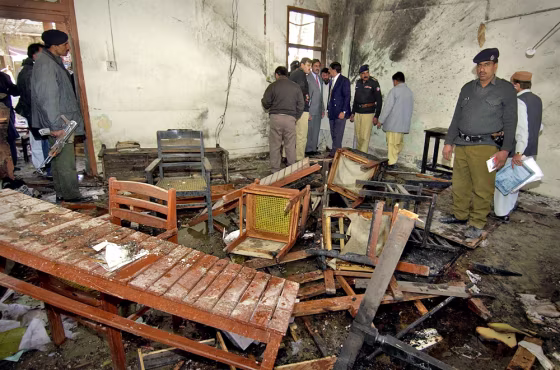Pakistani policemen inspect wreckage at