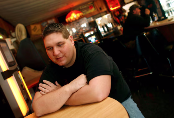Joshua Hanson talks Tuesday at his bar in Blair, Wis., about the before and after of his 16-story fall.