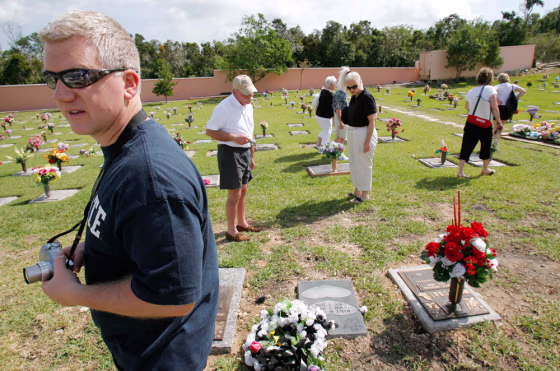 Tourists look for the location of the gravesite of Anna Nicole Smith's son, Daniel, at Lakeview Memorial Gardens in Nassau