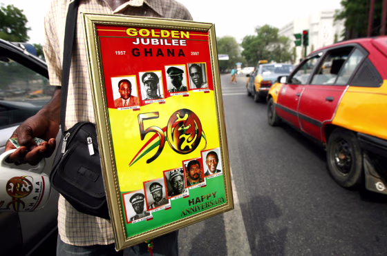 A street vendor walks with a placard fea