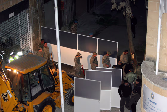 Greek Cypriots set up aluminium sheets as barriers on Cyprus's Ledra Street in Nicosia