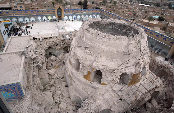 Iraqis gather at the ruins of a shrine in Samarra, 60 miles north of Baghdad, on Feb. 22, 2006, after a&nbsp;large explosion heavily damaged the golden dome of one of Iraq's most famous Shiite religious sites.