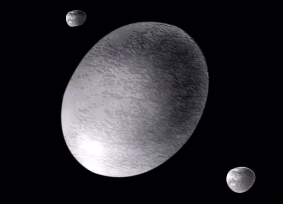 2003 EL61 is a dwarf planet located in the Kuiper Belt that is more than half the size of Pluto and shaped like a squashed American football. A new study finds that an ancient collision shattered it into several fragments, some of which became comets that might have found their way to Earth. Credit: 