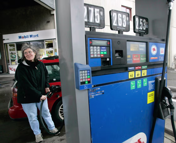Patti O'Connor pumps gas at a Mobil gas station in Cambridge, Mass.