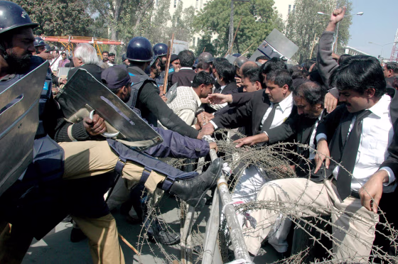 Pakistani lawyers scuffle with police during an anti-government rally in Lahore, Pakistan, on Friday.