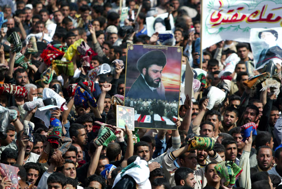 Iraqi Shiite Muslims waving their prayer
