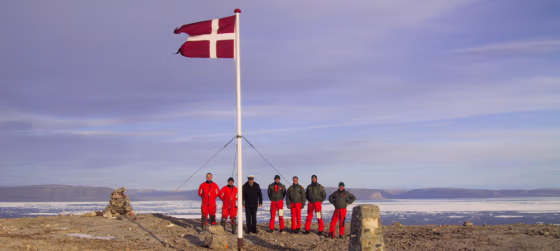 The crew of the Danish warship Vedderen&nbsp;raise Denmark's flag on the disputed&nbsp;Hans Island off Greenland in this Aug. 13, 2002, file photo.
