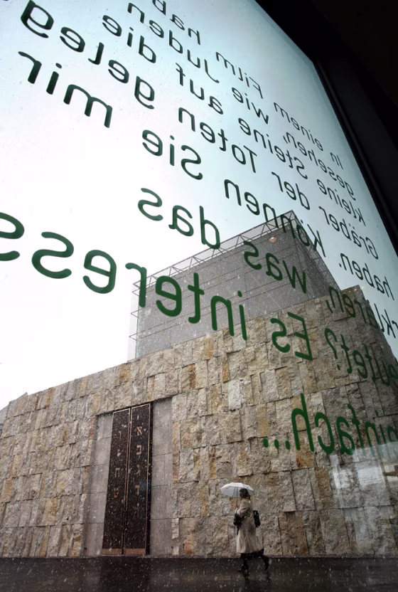 A person walks past the new synagogue in