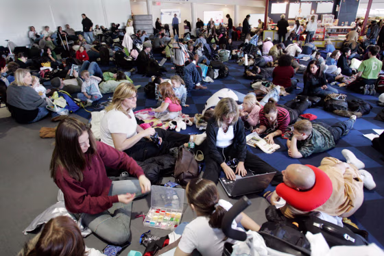 JetBlue Airways Corp. passengers fill the terminal floor as they wait for flights at New York's JFK earlier this year.