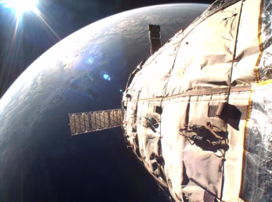 Earth takes on a golden lining in this March 20 picture, snapped by a camera aboard Bigelow Aerospace's Genesis 1 orbital module. Genesis 1's hull and solar panels are visible in the foreground.