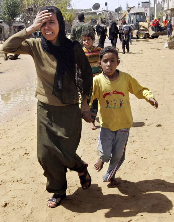 Palestinians run from the scene of a sewage flood in the village of Umm Naser, in the northern Gaza Strip, on&nbsp;Tuesday. 