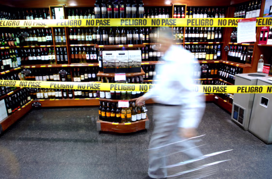 A man walks by alcohol barred from sale during certain hours at a supermarket in Caracas, Venezuela, on Saturday.