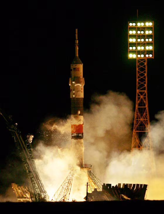 A Soyuz rocket blasts off from the Baikonur Cosmodrome in Kazakhstan on Saturday, carrying U.S. billionaire Charles Simonyi and two Russian cosmonauts toward the international space station.