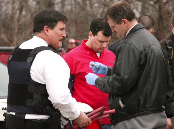 Anthony LaCalamita, center,&nbsp;is arrested Tuesday near Troy, Mich., following a shooting that left a woman dead and two men wounded.