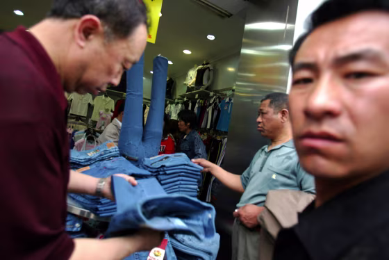 Customers look through clothing at a store in Beijing.&nbsp;China's sizzling economy jumped 11.1 percent in the first quarter, raising prospects the government will take further measures to cool growth.