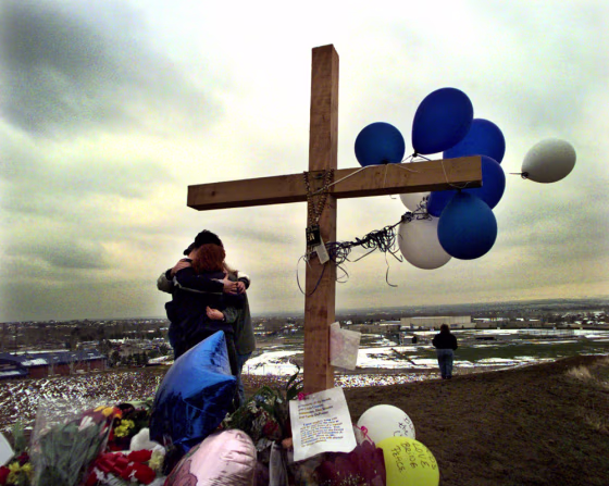 Students embrace each other at a makeshift memorial for their classmates killed at Columbine High School on a hilltop overlooking the school in Littleton, Colo., in April 1999.