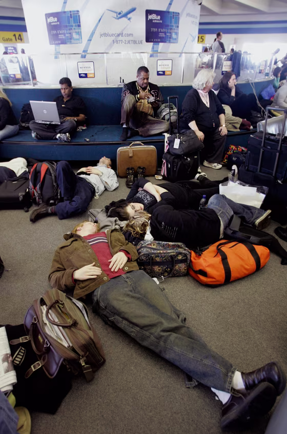 JetBlue passengers sleep and work on computers as they wait for flights at New York's John F. Kennedy Airport.&nbsp;A snow and ice storm back in February resulted in more than 1,000 flight cancelations and headaches for hordes of travelers.
