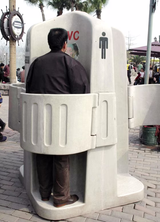 A man uses a controversial outdoor toilet in southwest China's Chongqing Municipality