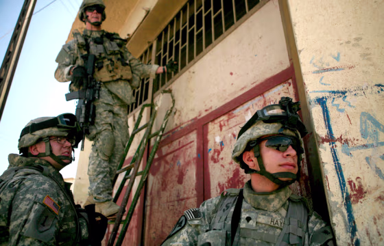 From left: Sgt. Jesse Flannery,&nbsp;Sgt. Toby Thompson and&nbsp;Spc. Joshua Hays use a ladder Monday to enter a&nbsp;shop while searching for clues about recent bombings in Mosul, 225 miles northwest of Baghdad.