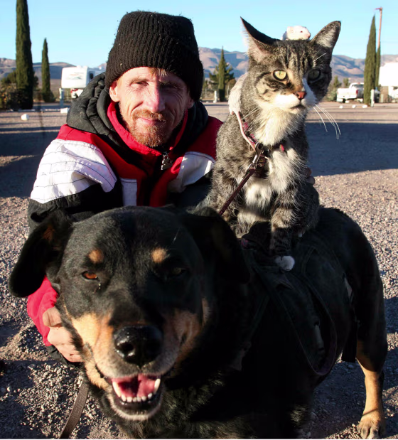 Greg Pike with his dog, cat and mice at his home in Naco, Arizona
