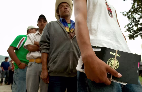 Mexicans line up outside the U.S. Consulate in Monterrey, Mexico, as they wait for a working visa interview, on Thursday.