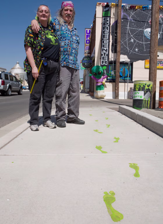 "We would welcome something like an alien roller coaster or a theme park, absolutely," said Sharon Welz, left, who is seen with her husband Larry Welz outside the couple's alien-themed store in Roswell, N.M., on May 22.