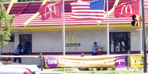 Hampton police officers stand outside&nbsp;the McDonald's restaurant Monday where the supposed hostage standoff unfolded.