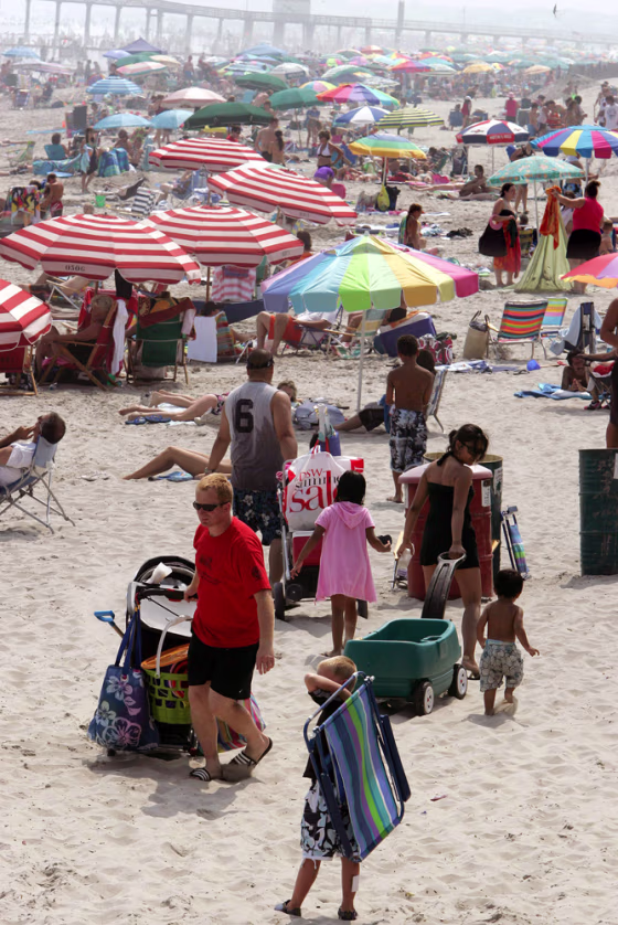 People walk on a crowded beach in Ocean City, N.J., Tuesday, July 17, 2007.