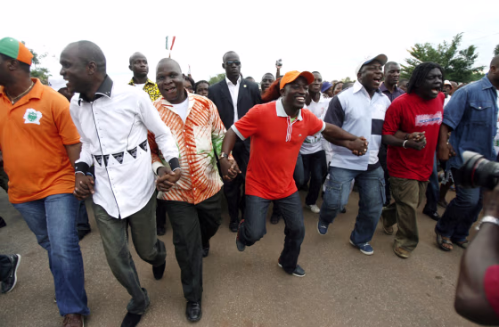 Charles Ble Goude, leader of Ivory Coast's Young Patriots, dances as he arrives with his delegation in Bouake