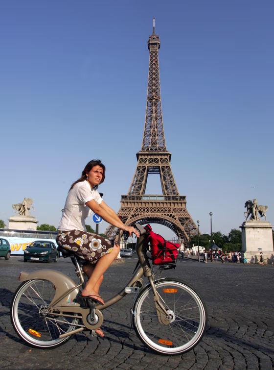 A rider uses a new bicycle provided by Paris City Hall, around the Eiffel Tower in Paris. More than 10,600 bikes are posted at 750 stations all over the city and prices start at a euro (U.S. $1.36) for a one-day pass. Users can take a bike and put it back at any station around town.