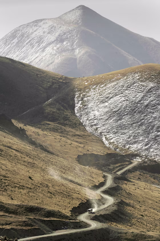 A bus travels up the treacherous road to