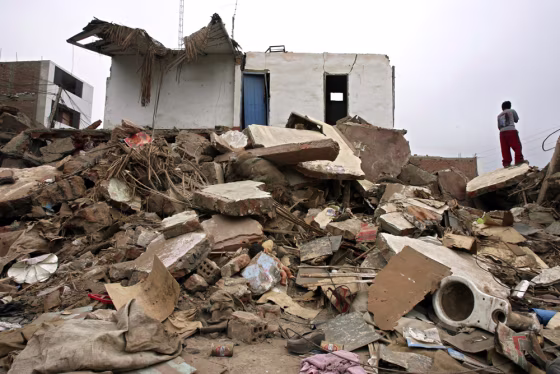 A boy&nbsp;surveys damage on Monday in Pisco, Peru, where last week's&nbsp; earthquake destroyed more than 85 percent of the homes. 