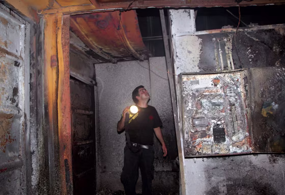 An Israeli man examines the damage caused by fire to the only crematorium in Israel. 