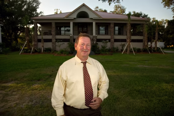 Aulton Vann Jr. stands in front of his new beachfront home in Pascagoula, Miss.