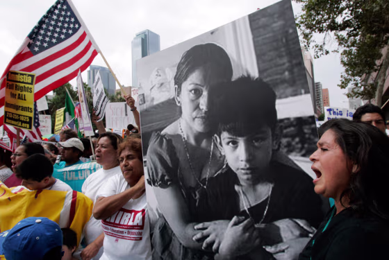 Protesters carry a portrait of immigration activist Elvira Arellano and her 8-year-old son, Saul, during a demonstration in Los Angeles on Saturday. Arellano was deported after leaving a Chicago church where she had taken refuge to draw attention to the plight of illegal immigrant parents. 