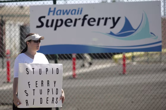 Protester Bonnie Bias of Maui stands in front of the terminal entrance to the Hawaii Superferry in Wailuku, Maui, on Sunday.