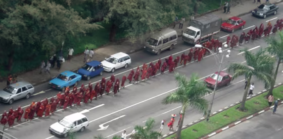Buddhist monks march whilst chanting prayers and holy scriptures in Yangon