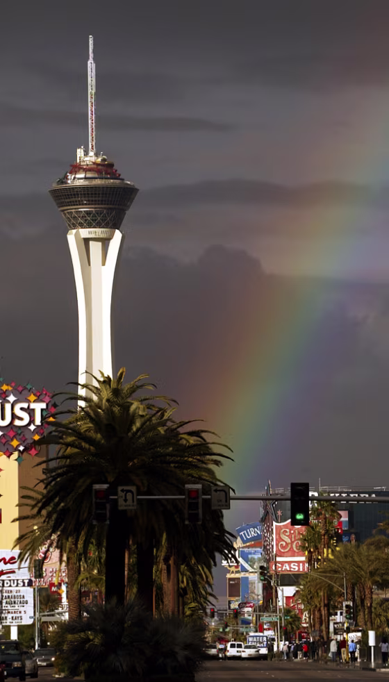 A rainbow illuminates the Stratosphere and the Las Vegas Boulevard 'strip'. Stay in Sin City on the cheap with an air/hotel package from United and Southwest Airlines, starting at $159.