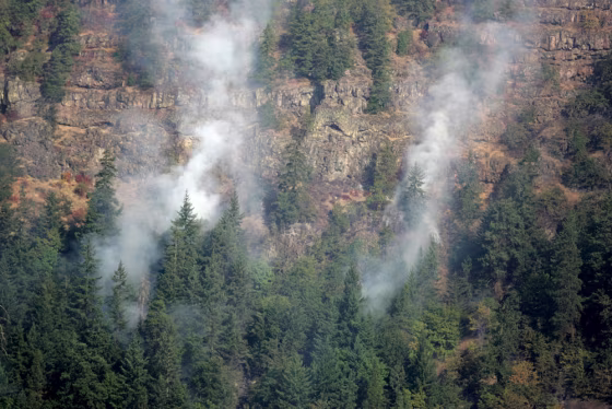 A wildfire burns along the cliffs overlooking the Columbia River near White Salmon, Wash., on Friday.