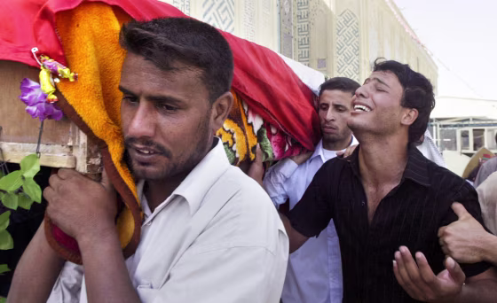 Shaker Dana, right, weeps for his brother Wisam Dana, 27, in Najaf, Iraq on Wednesday. The Iraqi soldier was killed by a car bomb in Anbar province on Monday.