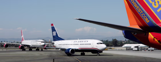 Planes from US Airways and Virgin Atlantic wait between terminals one and two to taxi at LAX last month. 