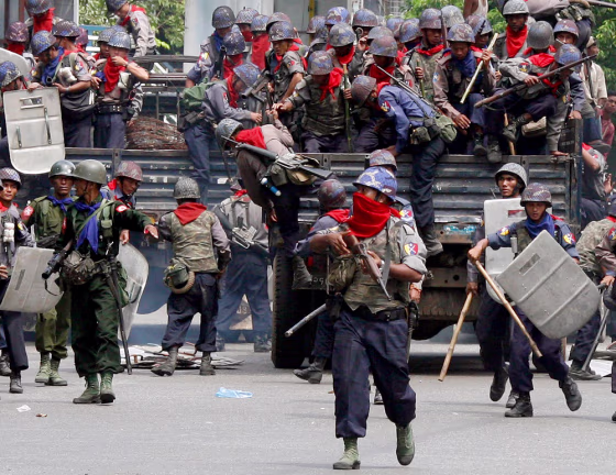 Riot police and military personnel arrive at the scene of an anti-government protest in Yangon's city centre