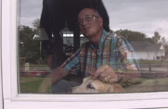 Gary C. Lindsey, a former school teacher accused of sexually abusing several of his students, appears with his dog in this image from video made at his home outside Cedar Rapids, Iowa, on Sept. 7.