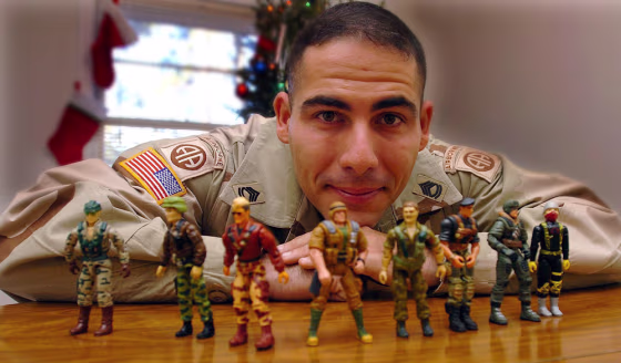 Sgt. 1st Class Jerry Wolford poses with his son's GI Joes in Fayetteville, N.C. Wolford will model for&nbsp;a new line of figures based on a new Army-sponsored video game, in which players will be able to "play" Wolford.