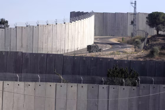 An Israeli military jeep drives past the